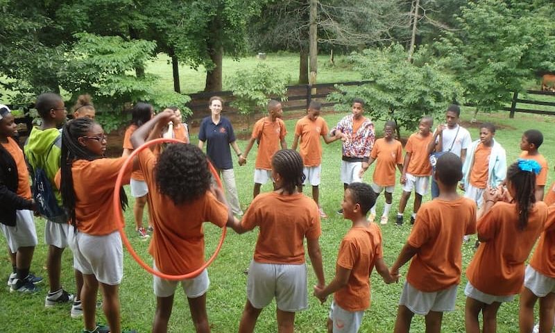 Kids standing in a circle to do an activity at Camp Dogwood