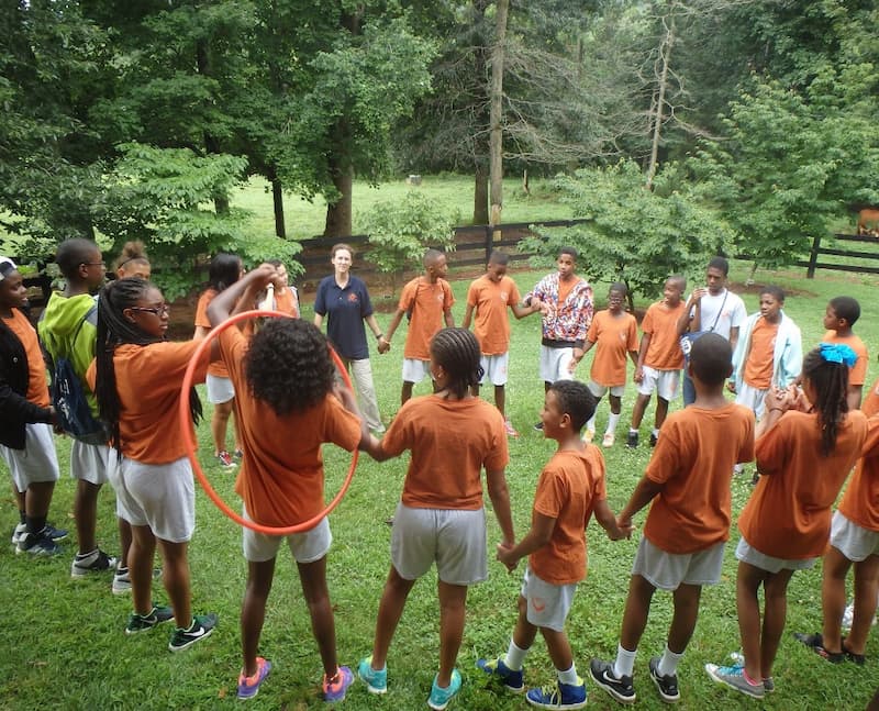 Kids standing in a circle to do an activity at Camp Dogwood