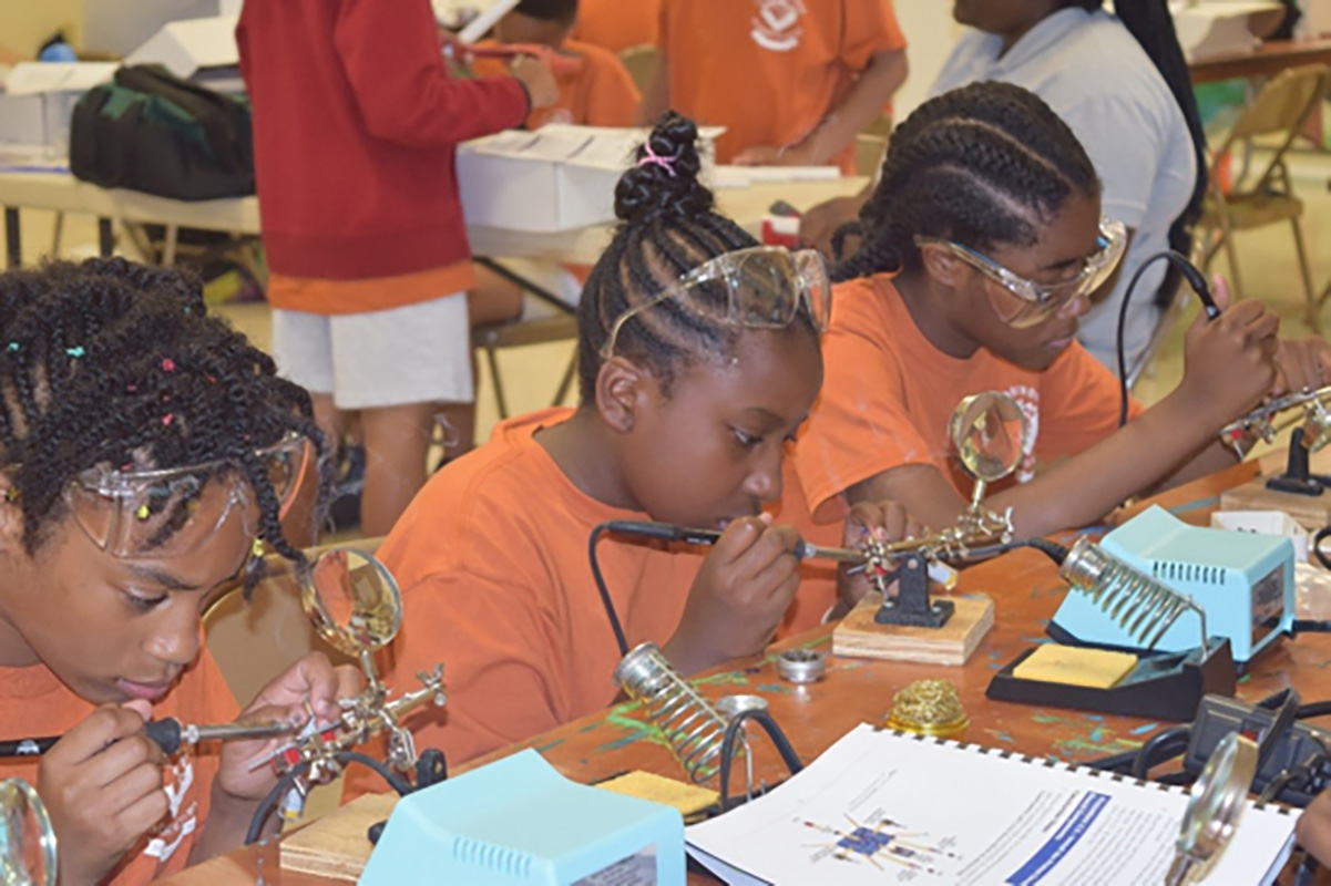 Girls soldering at Camp Dogwood